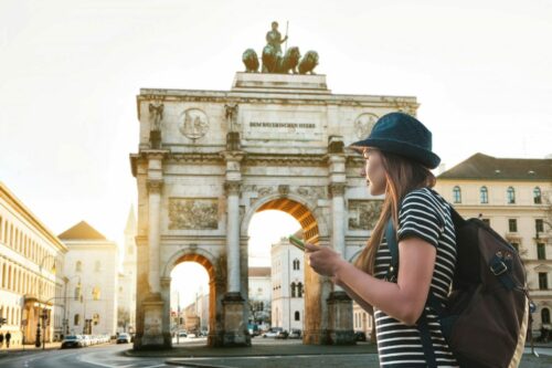 A,Tourist,Girl,With,A,Backpack,Looks,Sights,In,Munich